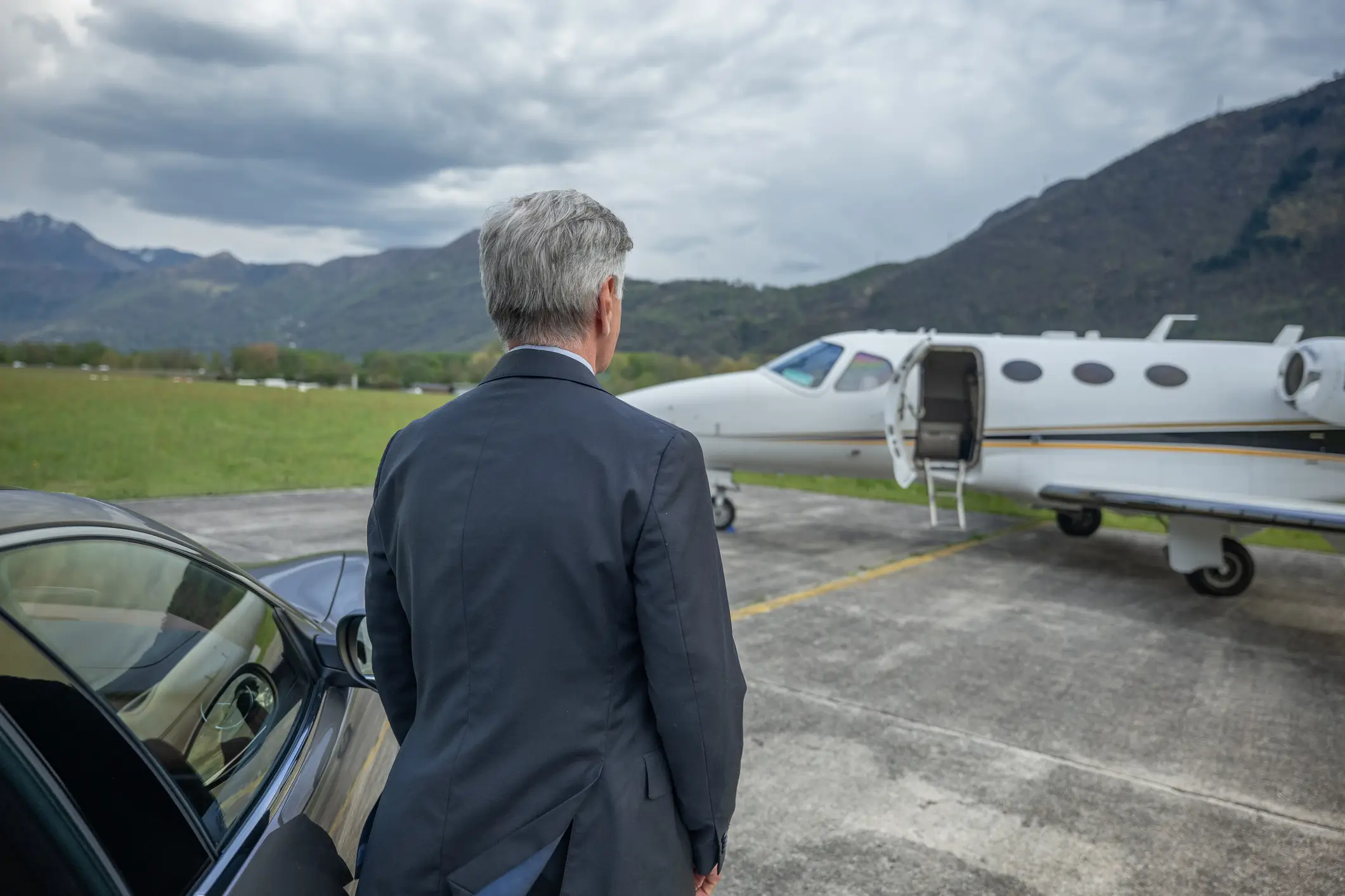 Man approaching private jet on tarmac.